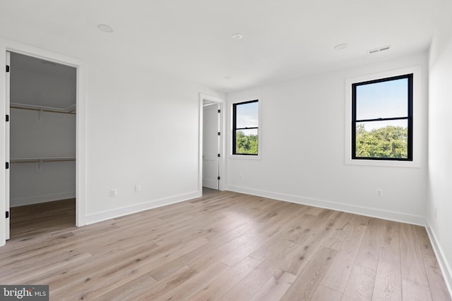 935 Dead Run Dr, Mclean, VA 22101 - unfurnished bedroom with baseboards, light wood-style floors, and a walk in closet