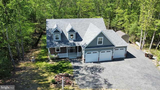 130 Corktree Rd, Kunkletown, PA 18058 - view of front of home featuring covered porch, asphalt driveway, a view of trees, and a garage