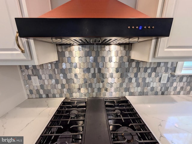 130 Corktree Rd, Kunkletown, PA 18058 - detailed view of custom exhaust hood, gas stovetop, tasteful backsplash, white cabinets, and light stone countertops