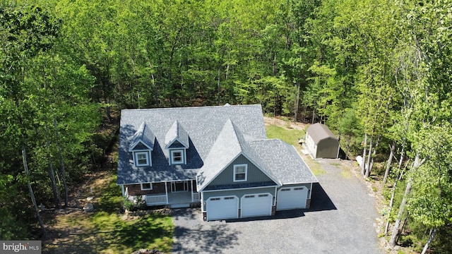 130 Corktree Rd, Kunkletown, PA 18058 - view of front of property featuring covered porch, driveway, an attached garage, and a forest view