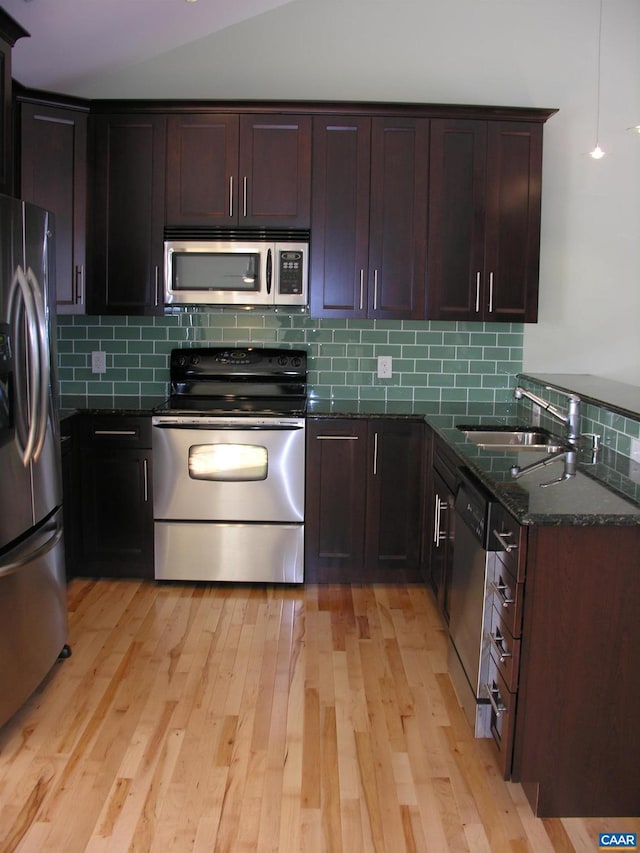 101 Sterling Dr, Waynesboro, VA 22980 - kitchen with stainless steel appliances, a sink, dark stone countertops, tasteful backsplash, and light wood-style flooring