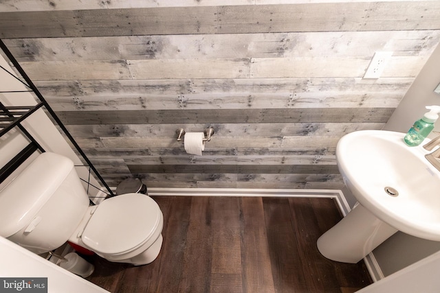104 Overlook Dr, Hanover, PA 17331 - bathroom with toilet, wood finished floors, a sink, and wooden walls