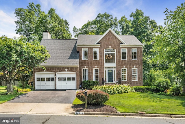 14519 Picket Oaks Rd, Centreville, VA 20121 - colonial inspired home featuring a garage, asphalt driveway, a front lawn, brick siding, and a chimney