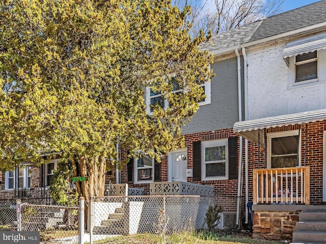 5443 Jonquil Ave, Baltimore, MD 21215 - townhome / multi-family property with stucco siding, brick siding, and roof with shingles