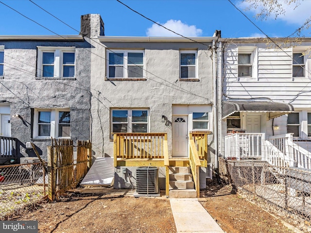 5443 Jonquil Ave, Baltimore, MD 21215 - townhome / multi-family property featuring central air condition unit, stucco siding, and a chimney