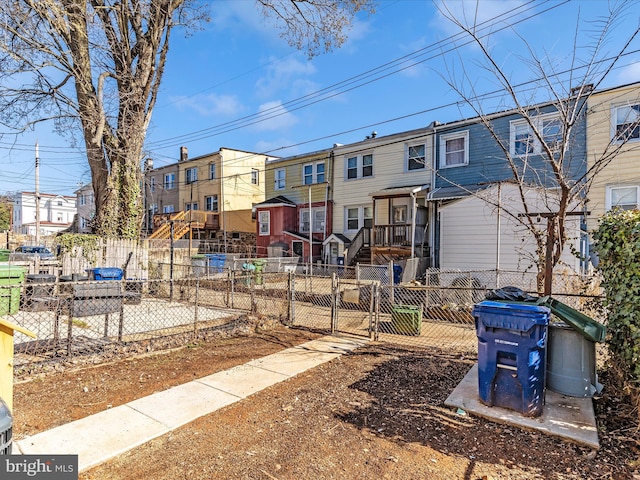 5443 Jonquil Ave, Baltimore, MD 21215 - rear view of house with a residential view, a fenced front yard, and a gate