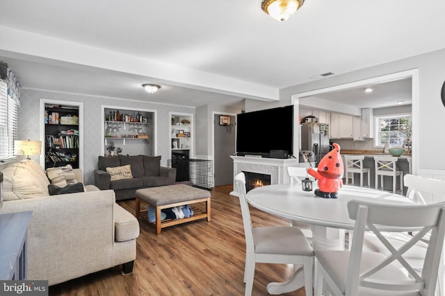 10317 Beaumont St, Fairfax, VA 22030 - living room featuring wood finished floors, a lit fireplace, and built in features