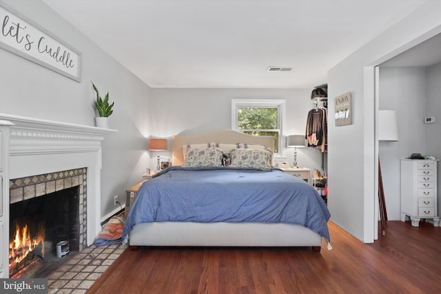 10317 Beaumont St, Fairfax, VA 22030 - bedroom featuring a tile fireplace and wood finished floors