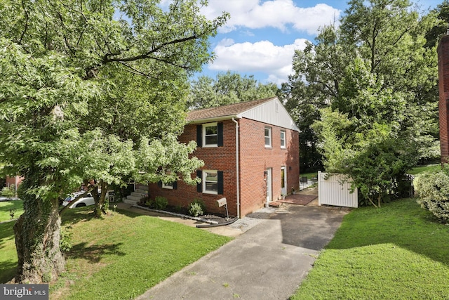 10317 Beaumont St, Fairfax, VA 22030 - colonial house featuring asphalt driveway, a front yard, and brick siding