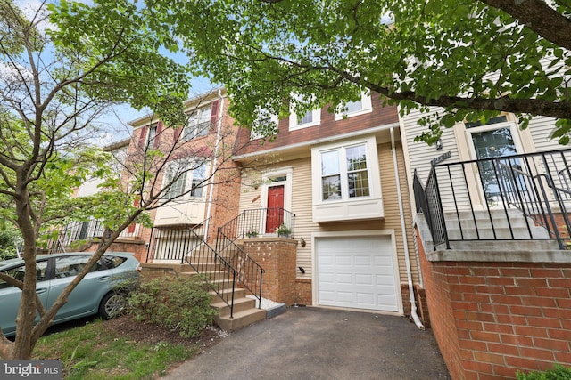 12220 Apple Orchard Ct, Fairfax, VA 22033 - townhome / multi-family property featuring an attached garage, asphalt driveway, and brick siding