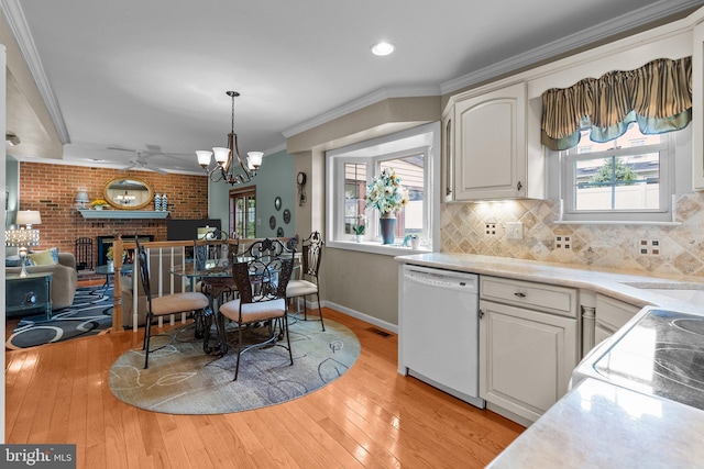 3604 Haystack Ln, Bensalem, PA 19020 - kitchen featuring white dishwasher, crown molding, a chandelier, open floor plan, and a brick fireplace