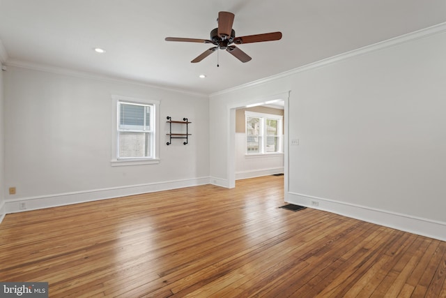 spare room with light wood-style flooring, ornamental molding, ceiling fan, baseboards, and recessed lighting
