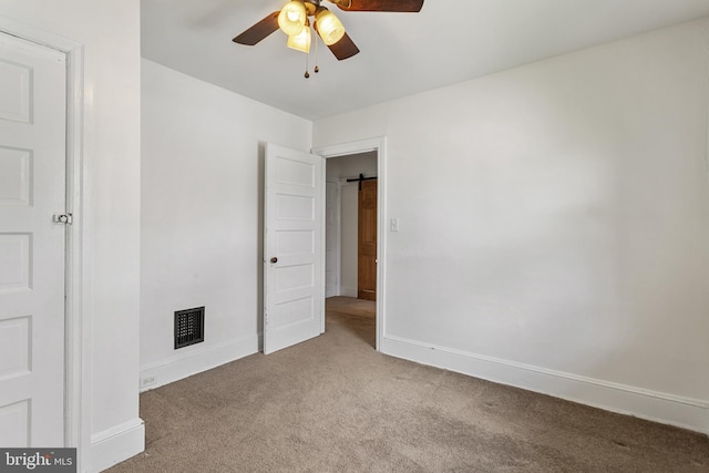 unfurnished bedroom featuring carpet, baseboards, and ceiling fan
