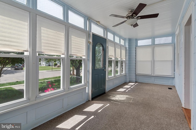 unfurnished sunroom with plenty of natural light and ceiling fan