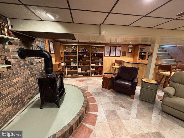 1472 Bearcat Cv, Auburn, PA 17922 - living area featuring a wood stove, stairs, tile patterned floors, and a paneled ceiling