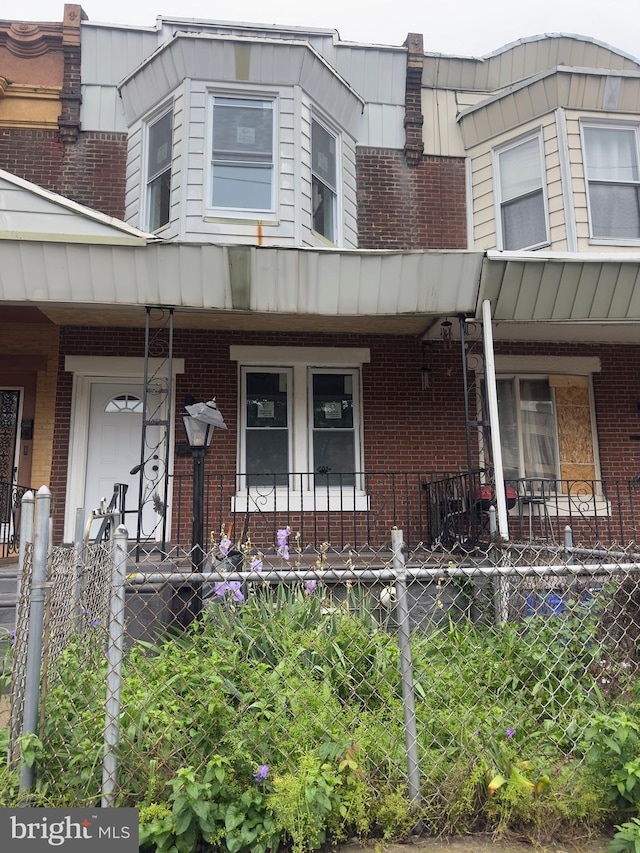 view of front of house featuring a porch and brick siding