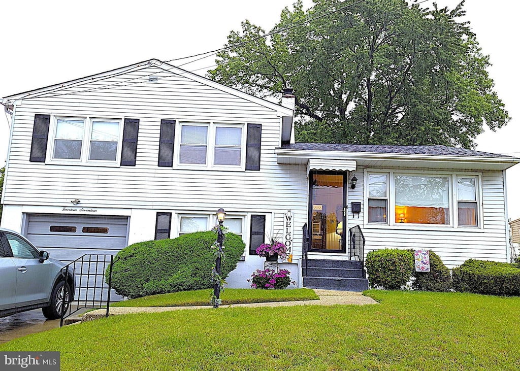 1417 Oriental Ave, Gloucester City, NJ 08030 - tri-level home featuring a garage, a front yard, and a chimney