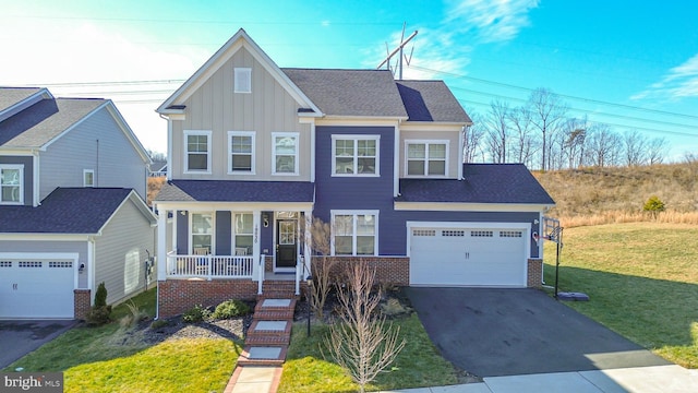 18030 Stump St, Dumfries, VA 22026 - view of front of home with a porch, board and batten siding, driveway, a front lawn, and a garage