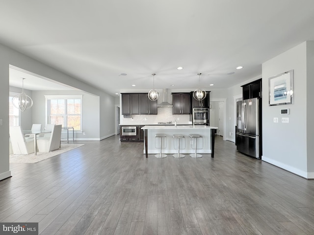 18030 Stump St, Dumfries, VA 22026 - kitchen with stainless steel appliances, light countertops, a breakfast bar area, recessed lighting, and baseboards