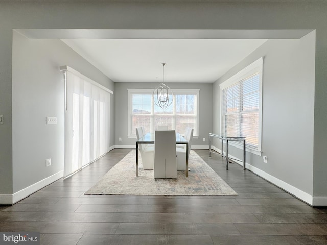 18030 Stump St, Dumfries, VA 22026 - dining space with a chandelier, dark wood finished floors, and baseboards