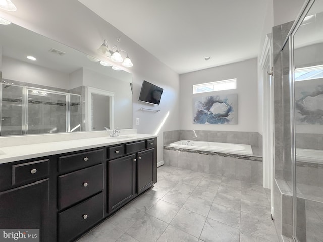 18030 Stump St, Dumfries, VA 22026 - bathroom with double vanity, a garden tub, and a shower stall