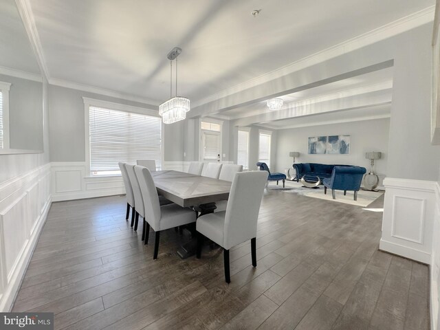 18030 Stump St, Dumfries, VA 22026 - dining area featuring a chandelier, dark wood-style floors, healthy amount of natural light, wainscoting, and crown molding