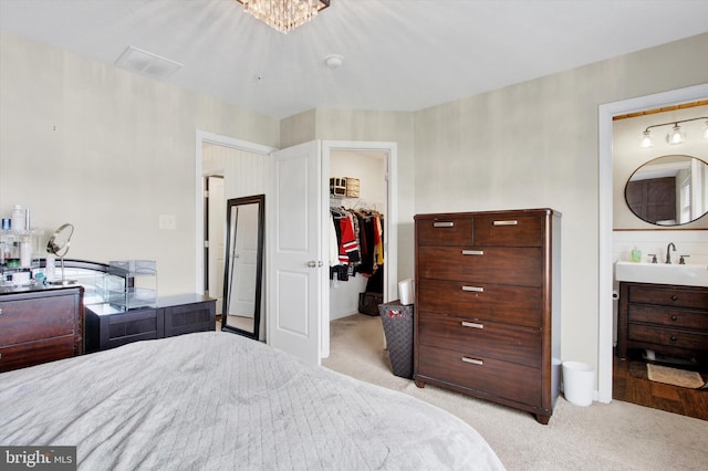 31 Holstein Dr, Hanover, PA 17331 - bedroom featuring light carpet, a sink, a walk in closet, and a closet