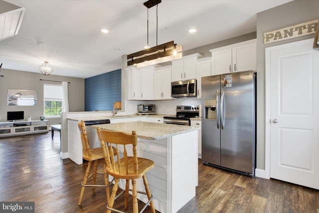 31 Holstein Dr, Hanover, PA 17331 - kitchen with stainless steel appliances, a peninsula, dark wood-style flooring, decorative backsplash, and recessed lighting