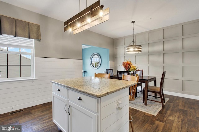 31 Holstein Dr, Hanover, PA 17331 - kitchen with dark wood-style floors, decorative light fixtures, white cabinetry, a center island, and a decorative wall
