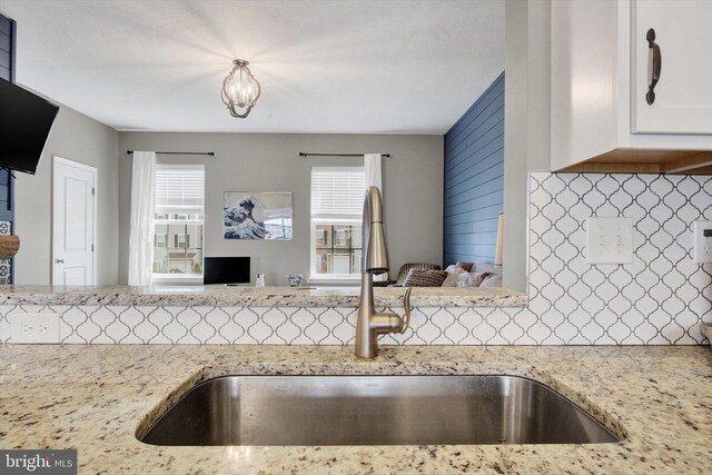 31 Holstein Dr, Hanover, PA 17331 - kitchen featuring a sink, decorative backsplash, white cabinets, and light stone countertops
