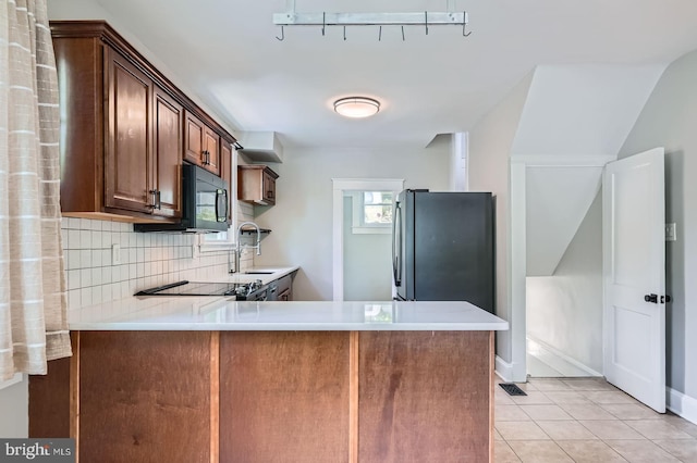 818 Glen Allen Dr, Baltimore, MD 21229 - kitchen with a sink, black appliances, light countertops, a peninsula, and decorative backsplash