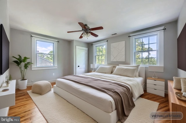 818 Glen Allen Dr, Baltimore, MD 21229 - bedroom featuring light wood finished floors, ceiling fan, and baseboards