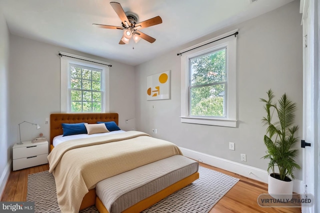 818 Glen Allen Dr, Baltimore, MD 21229 - bedroom with baseboards, wood finished floors, and ceiling fan