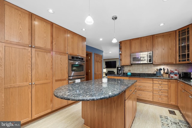 3 Franklin St, Stafford, VA 22556 - kitchen with stainless steel appliances, a kitchen island, light wood finished floors, glass insert cabinets, and tasteful backsplash