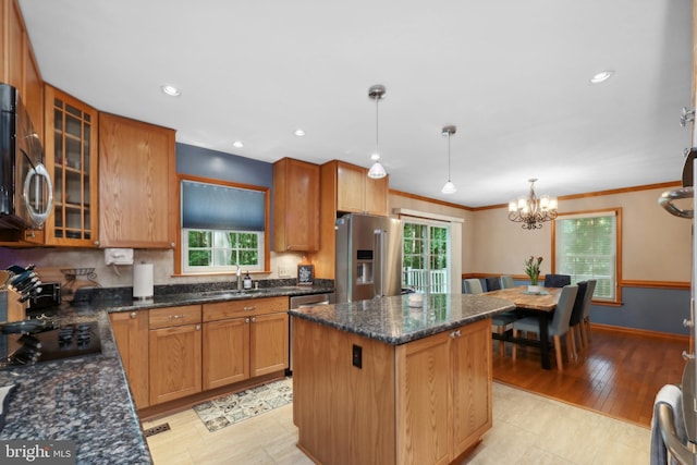 3 Franklin St, Stafford, VA 22556 - kitchen featuring appliances with stainless steel finishes, a sink, a kitchen island, glass insert cabinets, and a chandelier