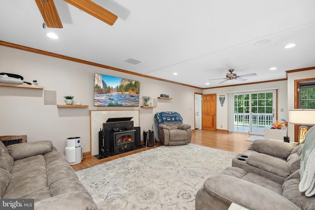 3 Franklin St, Stafford, VA 22556 - living room with a ceiling fan, crown molding, wood finished floors, recessed lighting, and a wood stove