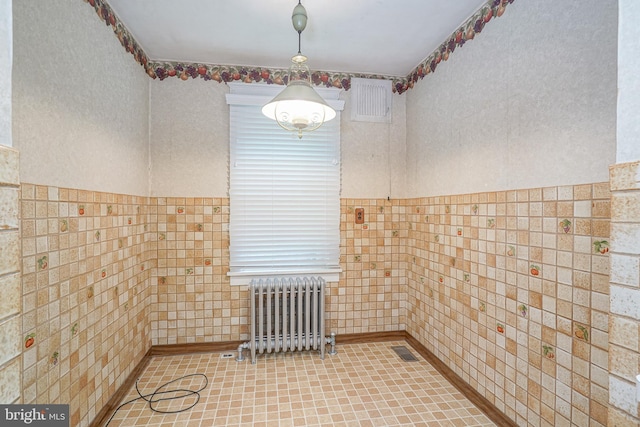 27 N Warren St, Woodbury, NJ 08096 - unfurnished dining area with radiator heating unit and tile walls
