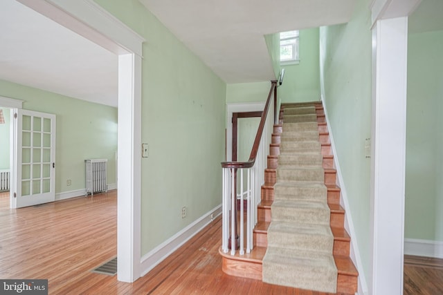 27 N Warren St, Woodbury, NJ 08096 - stairway with radiator, wood finished floors, and baseboards