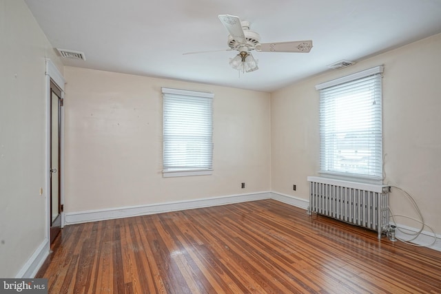 27 N Warren St, Woodbury, NJ 08096 - unfurnished room with radiator heating unit, plenty of natural light, hardwood / wood-style flooring, and a ceiling fan