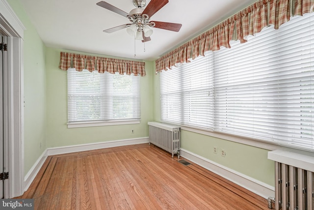 27 N Warren St, Woodbury, NJ 08096 - spare room with radiator, wood finished floors, baseboards, and a ceiling fan