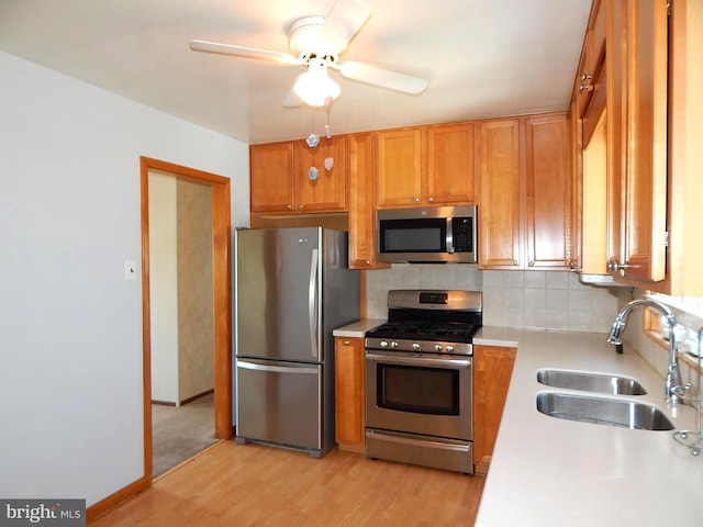 12 Gerard Rd, Hamilton, NJ 08620 - kitchen featuring stainless steel appliances, light countertops, light wood-style flooring, decorative backsplash, and brown cabinetry