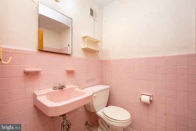 4021 Balwynne Park Rd, Philadelphia, PA 19131 - half bath with tile walls, toilet, a wainscoted wall, and a sink