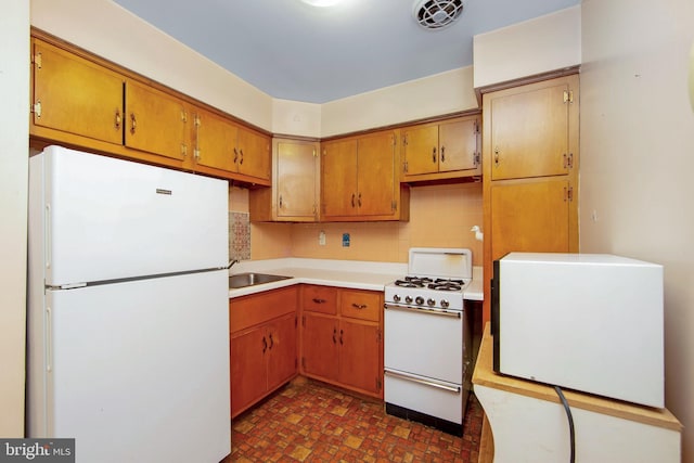 4021 Balwynne Park Rd, Philadelphia, PA 19131 - kitchen featuring white appliances, a sink, decorative backsplash, light countertops, and brown cabinets