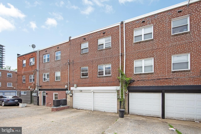 4021 Balwynne Park Rd, Philadelphia, PA 19131 - view of building exterior with driveway, an attached garage, and central AC unit