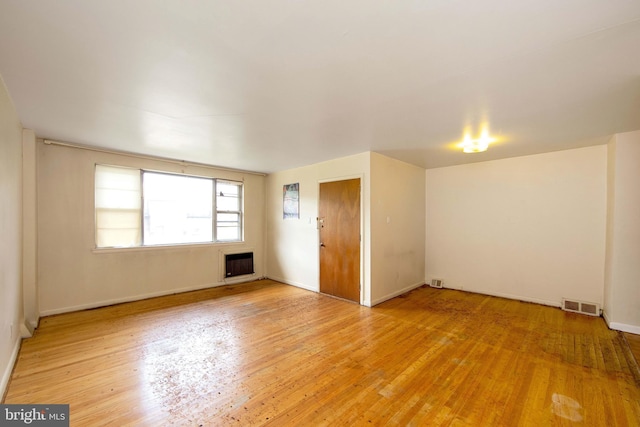 4021 Balwynne Park Rd, Philadelphia, PA 19131 - spare room featuring heating unit, light wood-style flooring, and baseboards