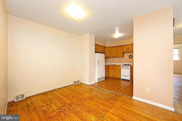4021 Balwynne Park Rd, Philadelphia, PA 19131 - kitchen with white appliances, light countertops, light wood-type flooring, and baseboards