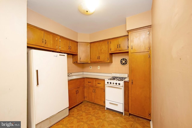 4021 Balwynne Park Rd, Philadelphia, PA 19131 - kitchen featuring white appliances, tasteful backsplash, brown cabinets, and a sink