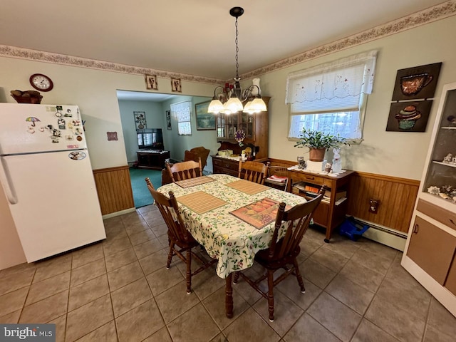 1954 High Park Mnr, Pottsville, PA 17901 - tiled dining area featuring a wainscoted wall, a chandelier, a baseboard radiator, and wooden walls