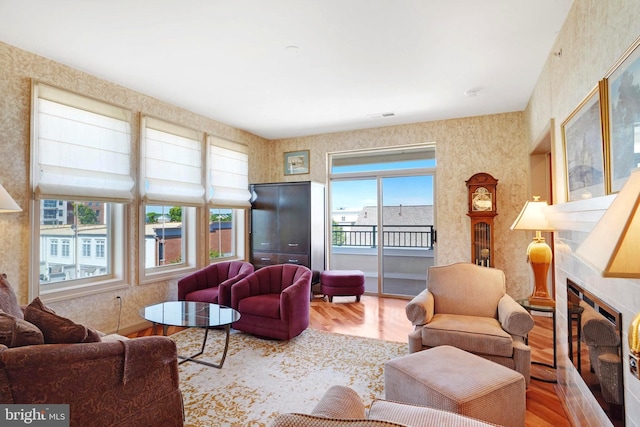 440 Belmont Bay Dr Unit 406, Woodbridge, VA 22191 - living area featuring a premium fireplace, wood finished floors, and wallpapered walls