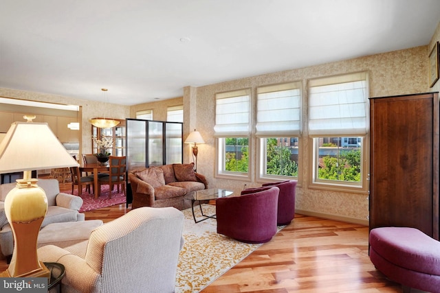 440 Belmont Bay Dr Unit 406, Woodbridge, VA 22191 - living area featuring wood finished floors and wallpapered walls